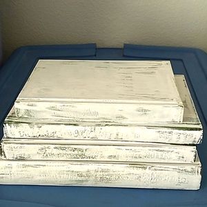 White painted hardcover books for decor or staging.